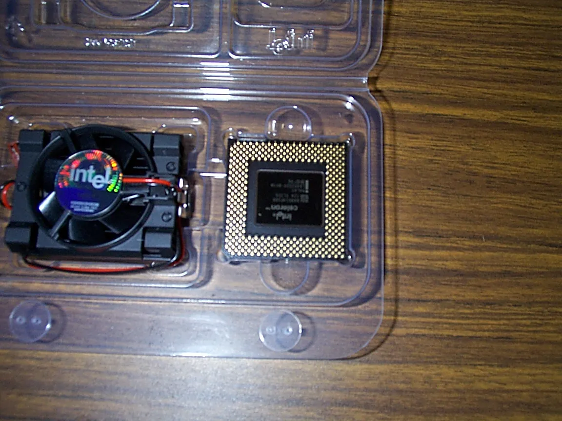 Celeron processor and fan in their opened packaging